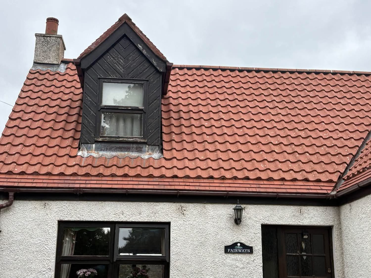 Red tiled roof and dormer on a white rendered cottage in East Lothian