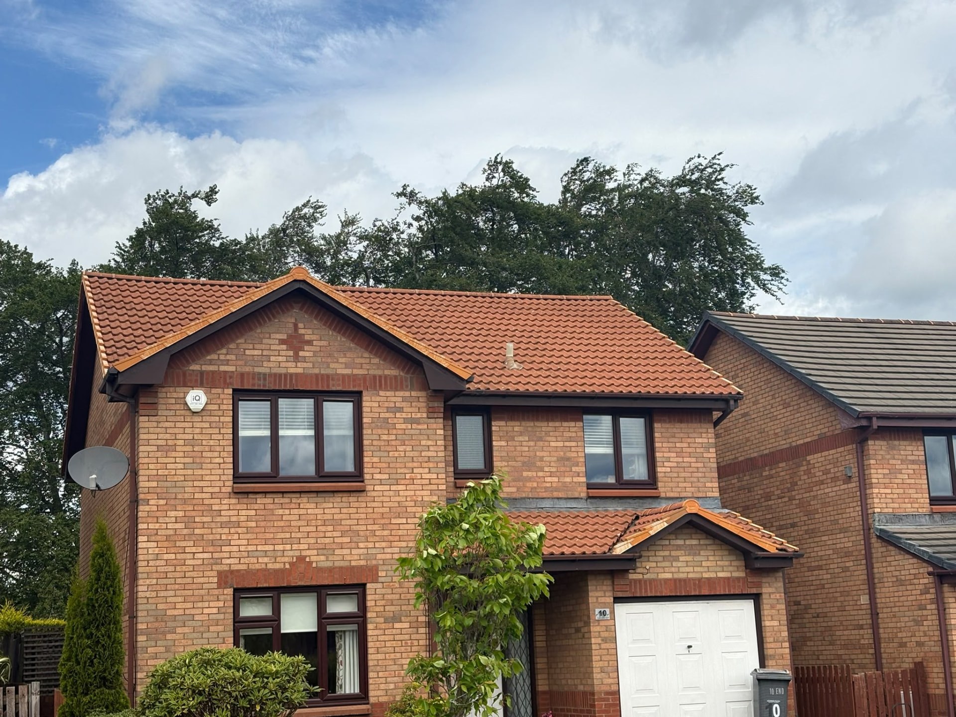 Red tiled roof and porch on a detached brick house in Edinburgh