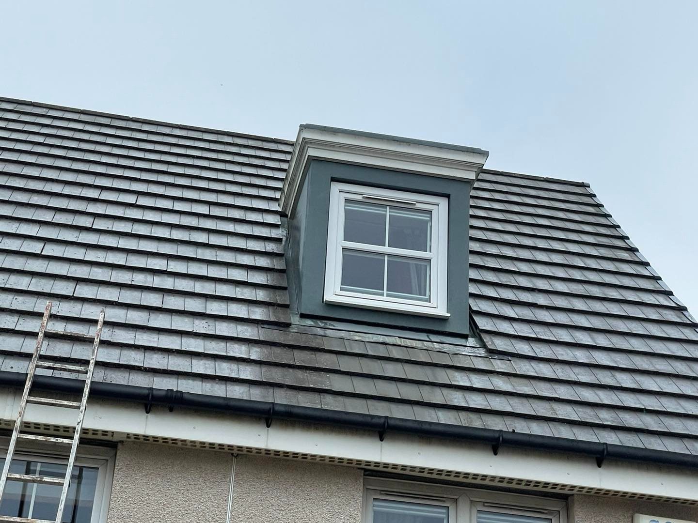 Grey tiled roof with dormer after biocide roof moss treatment in Edinburgh
