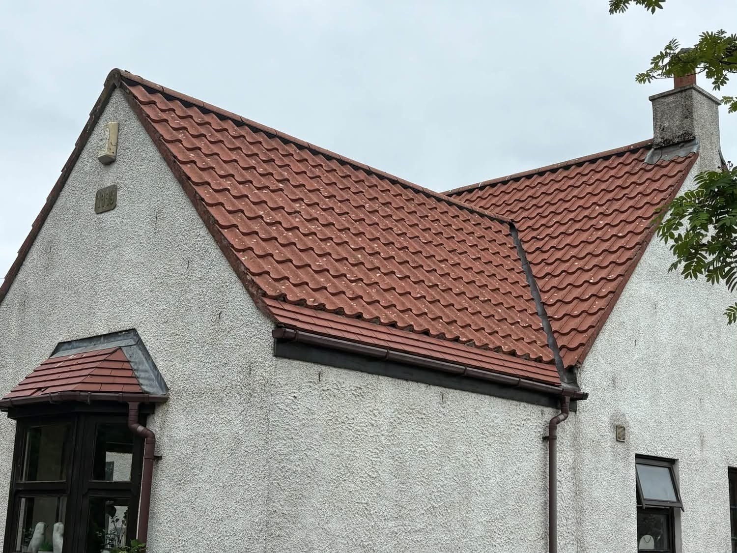 Red tiled gable roof on a white rendered house in East Lothian