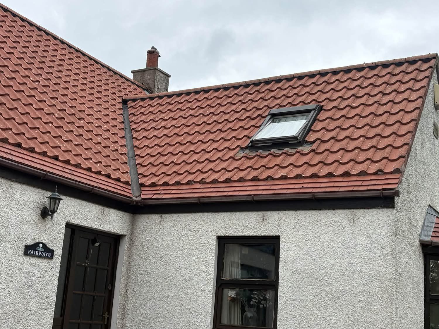 Red tiled roof with skylight on a white rendered house in East Lothian