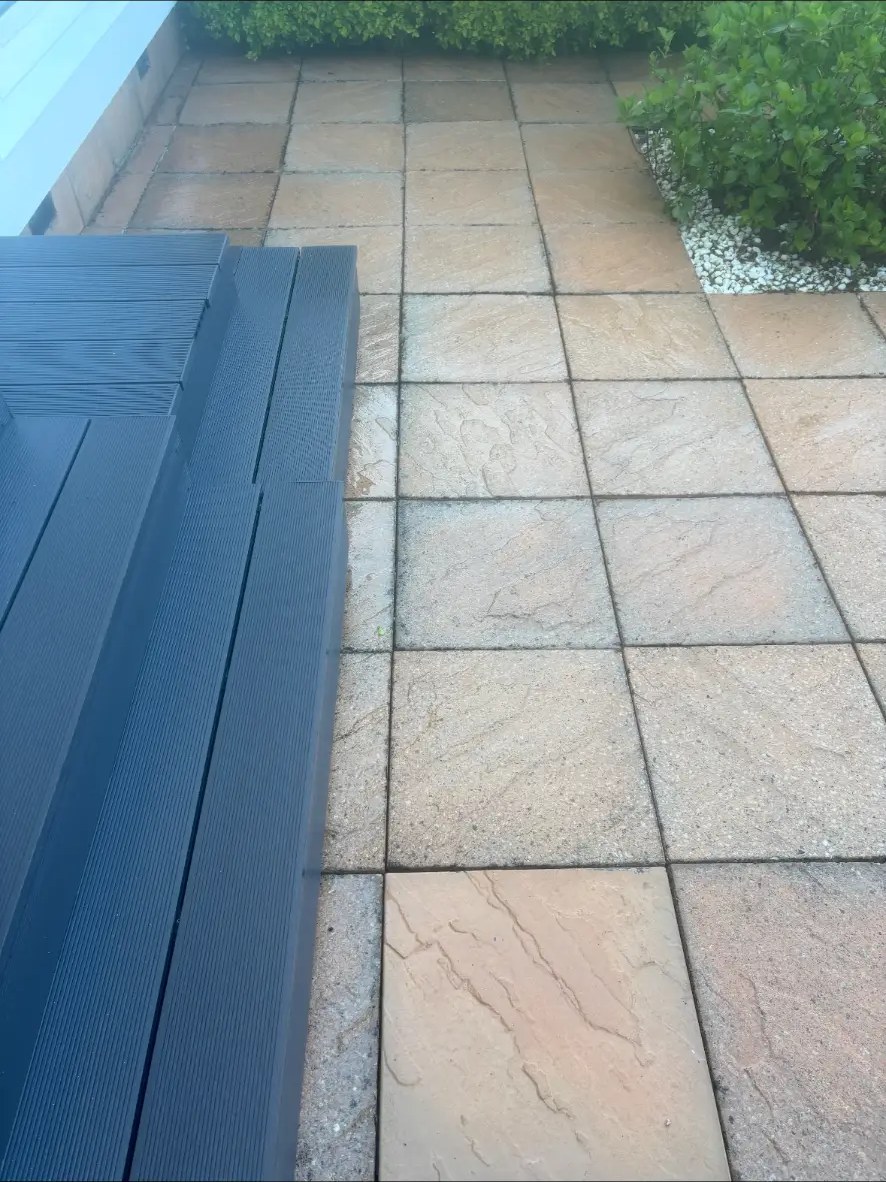 Clean slab patio beside decking after non-pressure cleaning in Midlothian