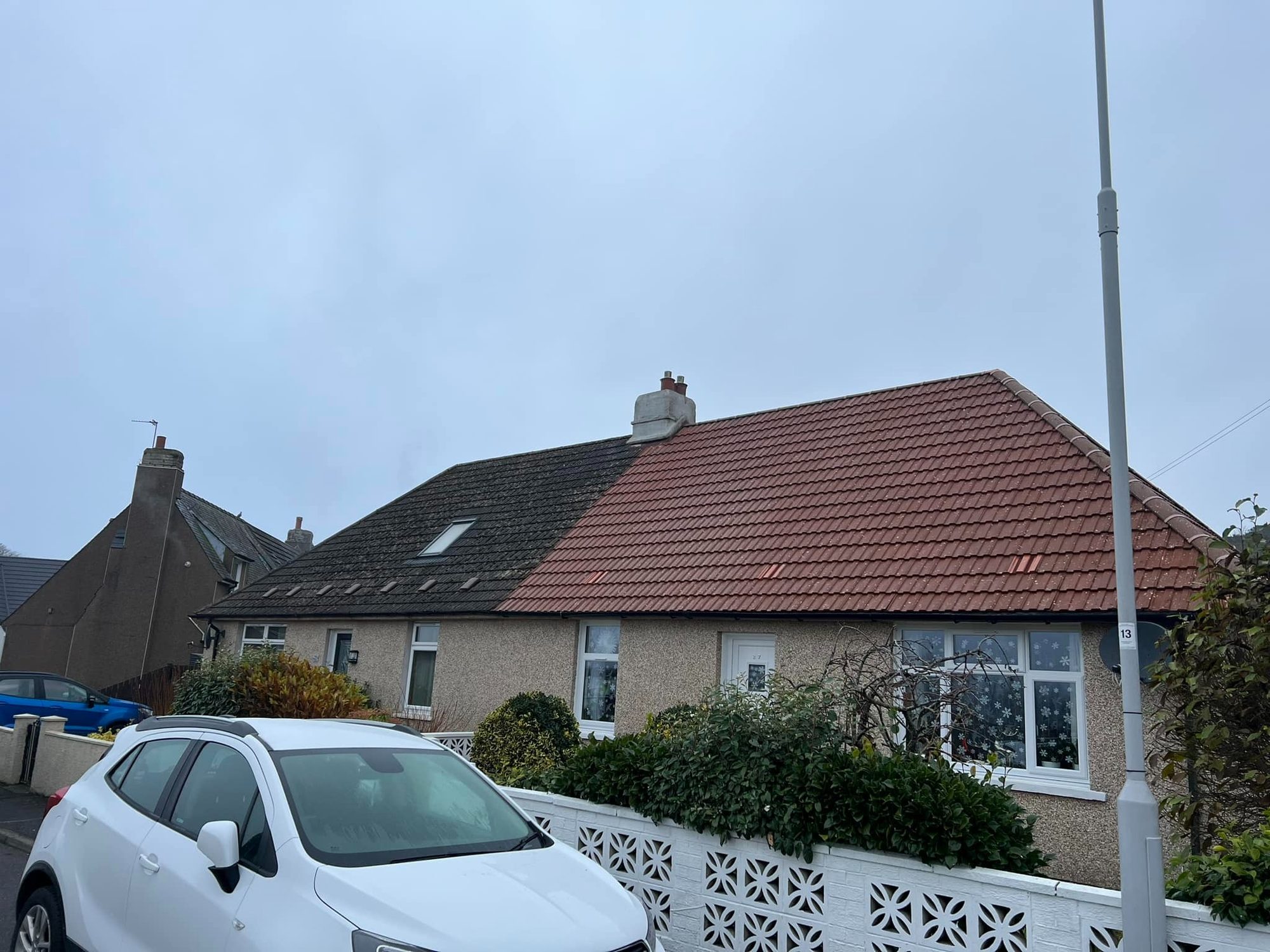 Red tiled bungalow roof after hand roof cleaning in Midlothian