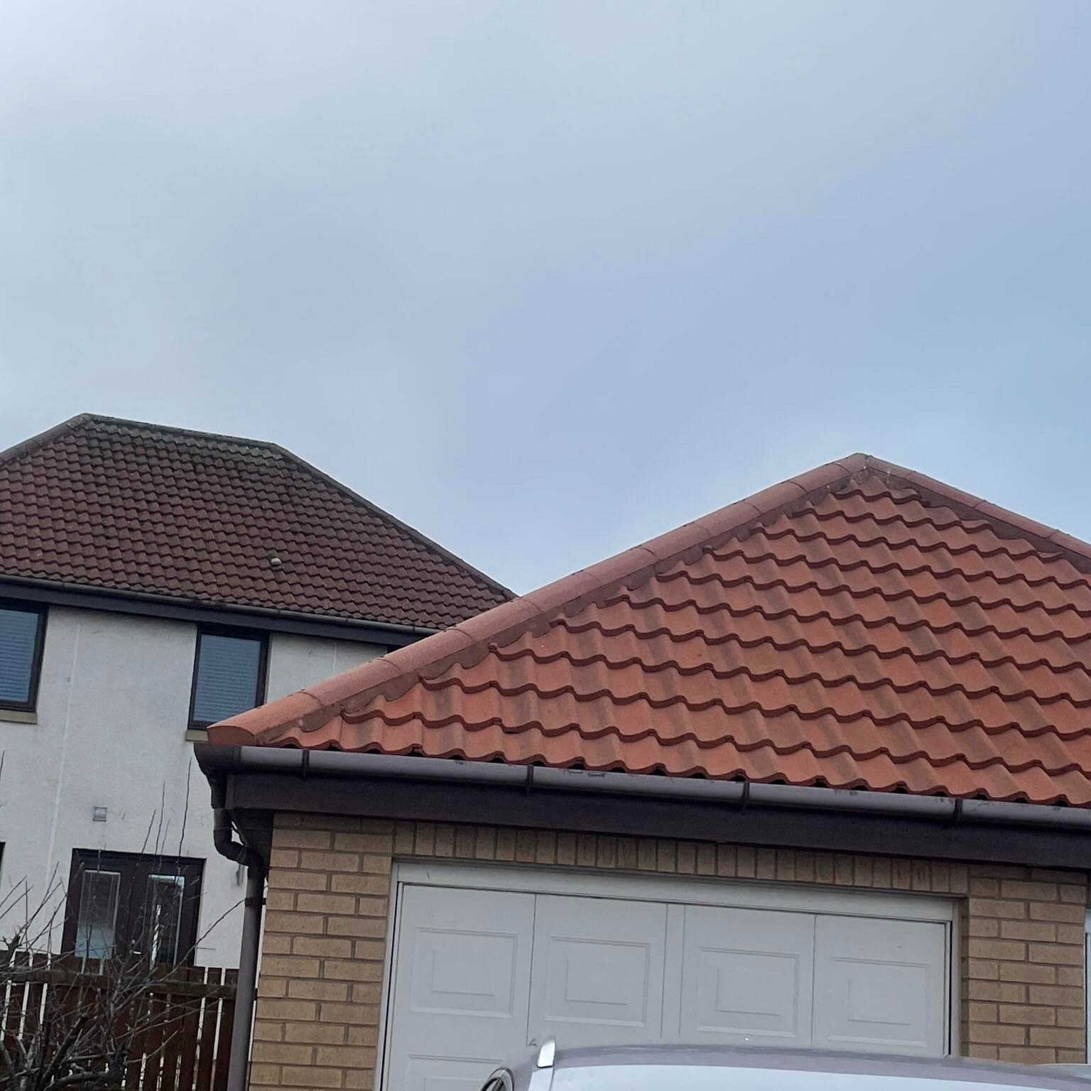 Clean red tiled garage roof after roof moss removal in Edinburgh