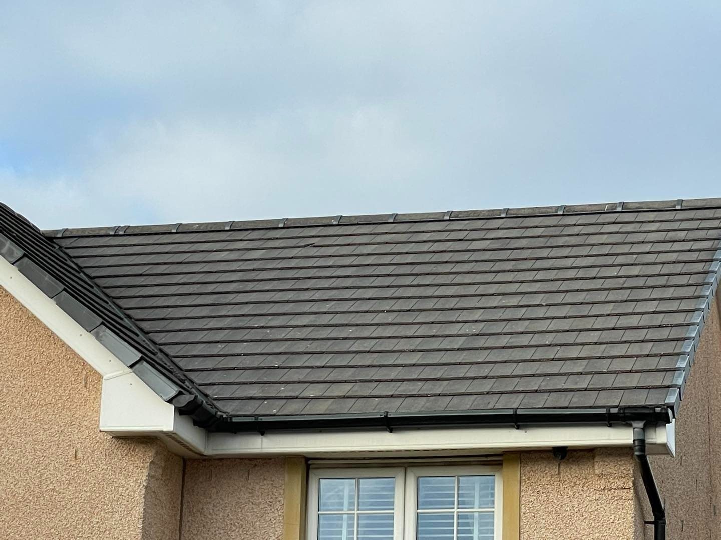 Clean grey tiled roof after biocide moss treatment in East Lothian
