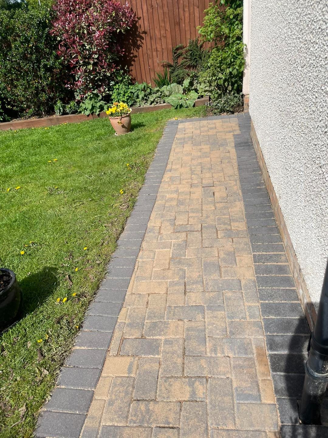 Clean block paving path beside a lawn in Edinburgh